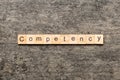 Competency word written on wood block. Competency text on table, concept Royalty Free Stock Photo