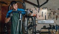 Competent bicycle mechanic in a workshop repairs a bike. Royalty Free Stock Photo