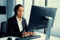 Competent female operator working on computer and while talking with clients. Royalty Free Stock Photo