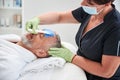 Professional spa worker doing skincare procedure for an aging man