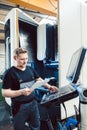 Worker in industrial workshop programming a cnc machine Royalty Free Stock Photo