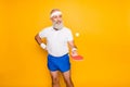 Competetive emotional cool active comic grandpa with beaming grin, with table tennis equipment. Healthcare, weight Royalty Free Stock Photo