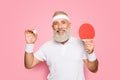 Competetive emotional cool active goofy comic grey haired grandpa with humor grimace and beaming grin, with table tennis