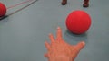 Reaching for a red dodgeball Royalty Free Stock Photo