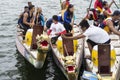 Competing teams of people embark on Sports Native Row Dragon head Boats during Dragon Cup Competition.