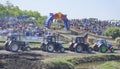 Competition for agricultural tractors on the green meadow. Bizo