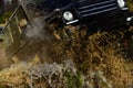 Competition, energy and motorsport concept. Car racing with dirty road. Off road vehicle or SUV crossing puddle with Royalty Free Stock Photo