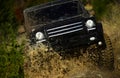 Competition, energy and motorsport concept. Off road vehicle or SUV crossing puddle with dirt splash. Car racing in Royalty Free Stock Photo