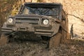 Competition of off-road cars. SUV is pulled out from puddle of mud by car winch. Royalty Free Stock Photo