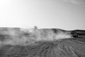 Competition racing challenge desert. Car overcome sand dunes obstacles. Car drives offroad with clouds of dust. Offroad