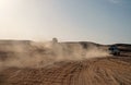 Competition racing challenge desert. Car overcome sand dunes obstacles. Car drives offroad with clouds of dust. Offroad