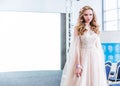 Competition of wedding stylists. A model in a pink airy wedding dress, with a hairstyle and make-up, walks along the