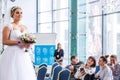 Competition of wedding stylists. Model In a wedding dress, with hair and make-up defecates around the stage. Minsk