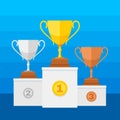 Competition winners podium with gold, silver and bronze trophy cups Royalty Free Stock Photo