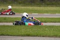 Competitions in children`s karting. Two pilots on subcompact racing cars. Selective focus