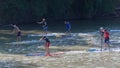 Competitiors in close quarters in a standup paddle board race