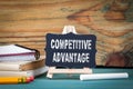 Competitive Advantage. small wooden board with chalk on the table Royalty Free Stock Photo