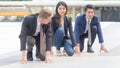 competitive business people in smart suite and cloth sit and prepare to start for running like athletic at outdoor pedestrian Royalty Free Stock Photo