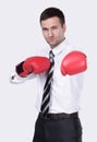 Competitive businessman in boxing gloves.