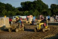 Competitive Mud spattered Lawn Mower Racing Royalty Free Stock Photo