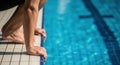 Competitive swimmer in crouched dive ready position by poolside Royalty Free Stock Photo