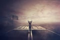 Competitive woman, raising hands up, celebrate on the road as crossing the finish line. Surreal challenge winning concept, Royalty Free Stock Photo