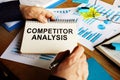 Competitor analysis report in the man hands