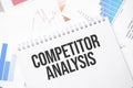 COMPETITOR ANALYSIS text on paper on the chart background with pen Royalty Free Stock Photo