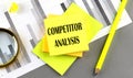 COMPETITOR ANALYSIS text on sticky on sticky on chart with pen Royalty Free Stock Photo