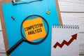 COMPETITOR ANALYSIS text on sticky on red notebook Royalty Free Stock Photo