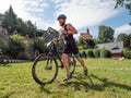 The competitor put on his shoes in the depot and jumps on the mtb