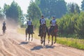 Competitors rival girls riding horses in summer field meadow.Young rider gallops through the summer sunny day