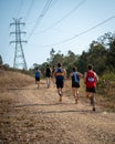 Competitors run up the bush trail under power lines in the Australian Mountain Running Championships Royalty Free Stock Photo