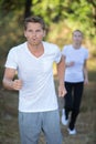 Competitors running in forest at endurance event Royalty Free Stock Photo