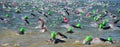 Competitors swimming out into open water at the beginning of Triathlon.