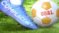 Complacency and a life goal - pictured as word Complacency on a football shoe to symbolize that Complacency can impact a goal and Royalty Free Stock Photo