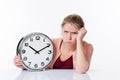 Complaining beautiful young woman holding a clock Royalty Free Stock Photo