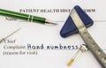Complaint hand numbness. Patient health history is on table of neurologist, which contains complaint hand numbness surrounded by n Royalty Free Stock Photo
