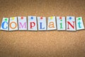 Complaint word suggesting customer support on cork panel Royalty Free Stock Photo