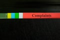 Complaints file record in black binder folder. Customer complaint business and crime concept.