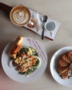a complete breakfast menu consisting of salad, wafel and coffee latte art