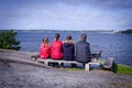 Complete family relaxing on sea coast