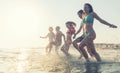 The complete family runs hand in hand from the beach to the sea, enjoying a joint vacation by the sea Royalty Free Stock Photo