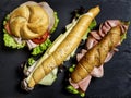 Complete healthy deli sandwich kornspitz whole grain european pretzel sticks salzstangerl and bread bun filled with meat slices Royalty Free Stock Photo