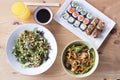 Complete healthy meal of sushi and salad on a wooden table