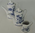 Complete set of milk and sugar service on a white background. Beautiful white dinner service with blue decoration.