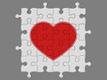 Completed mosaic from puzzles with symbol of heart Royalty Free Stock Photo