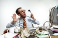 Young man tangled in wires on the workplace