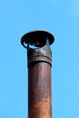 Completely rusted old retro vintage metal chimney with functional and decorative broken cap on top