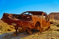 Completely rusted wrecked car in the desert hills of Tunisia under a blue sky Royalty Free Stock Photo